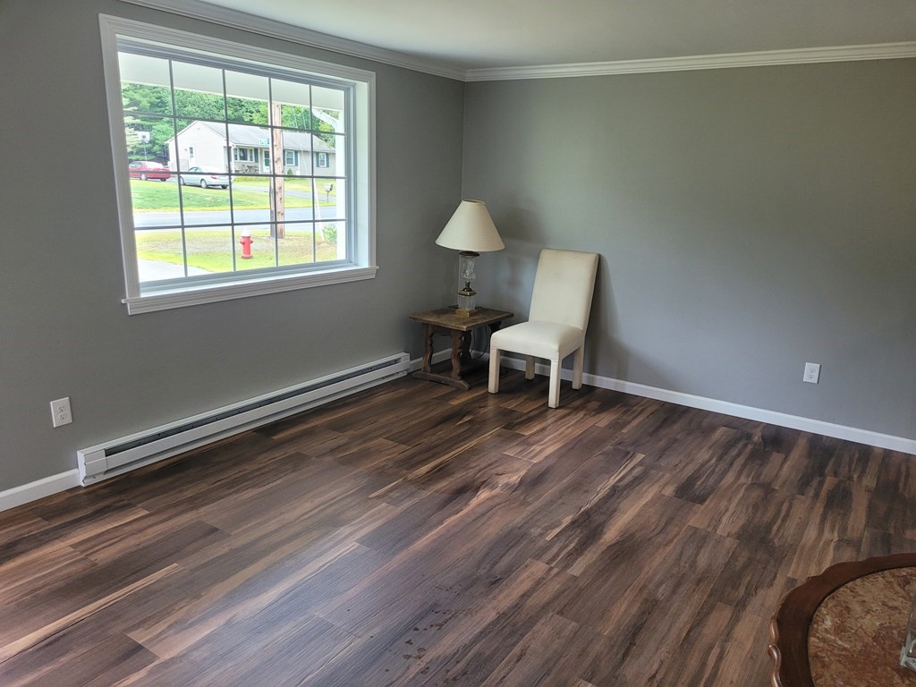 416 Southampton Road Holyoke, MA 01040 - Photo 3 of 12 a room with a window and a chair