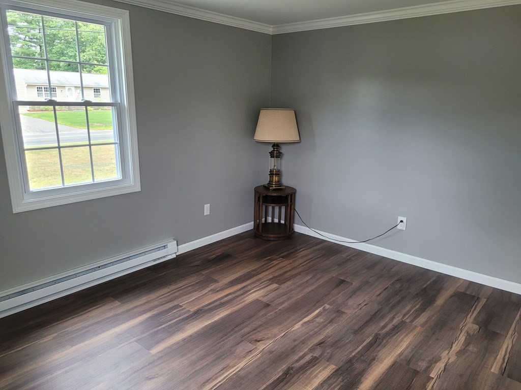 416 Southampton Road Holyoke, MA 01040 - Photo 6 of 12 a view of a livingroom with wooden floor and a window