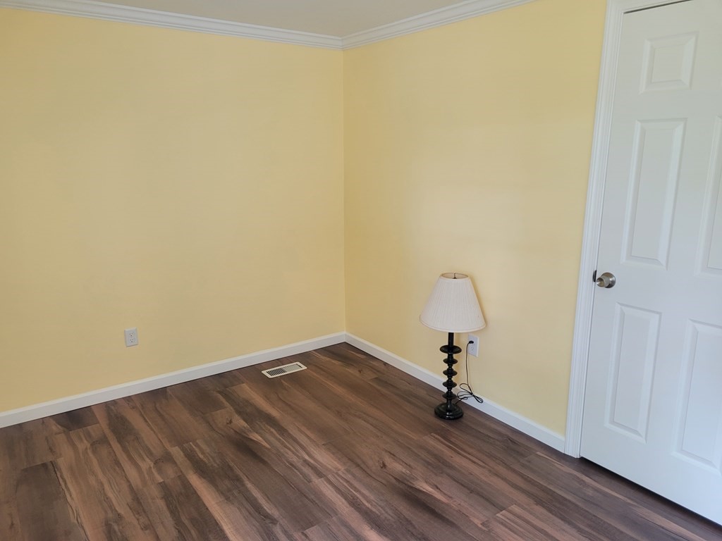 416 Southampton Road Holyoke, MA 01040 - Photo 7 of 12 a view of a room with wooden floor and fan