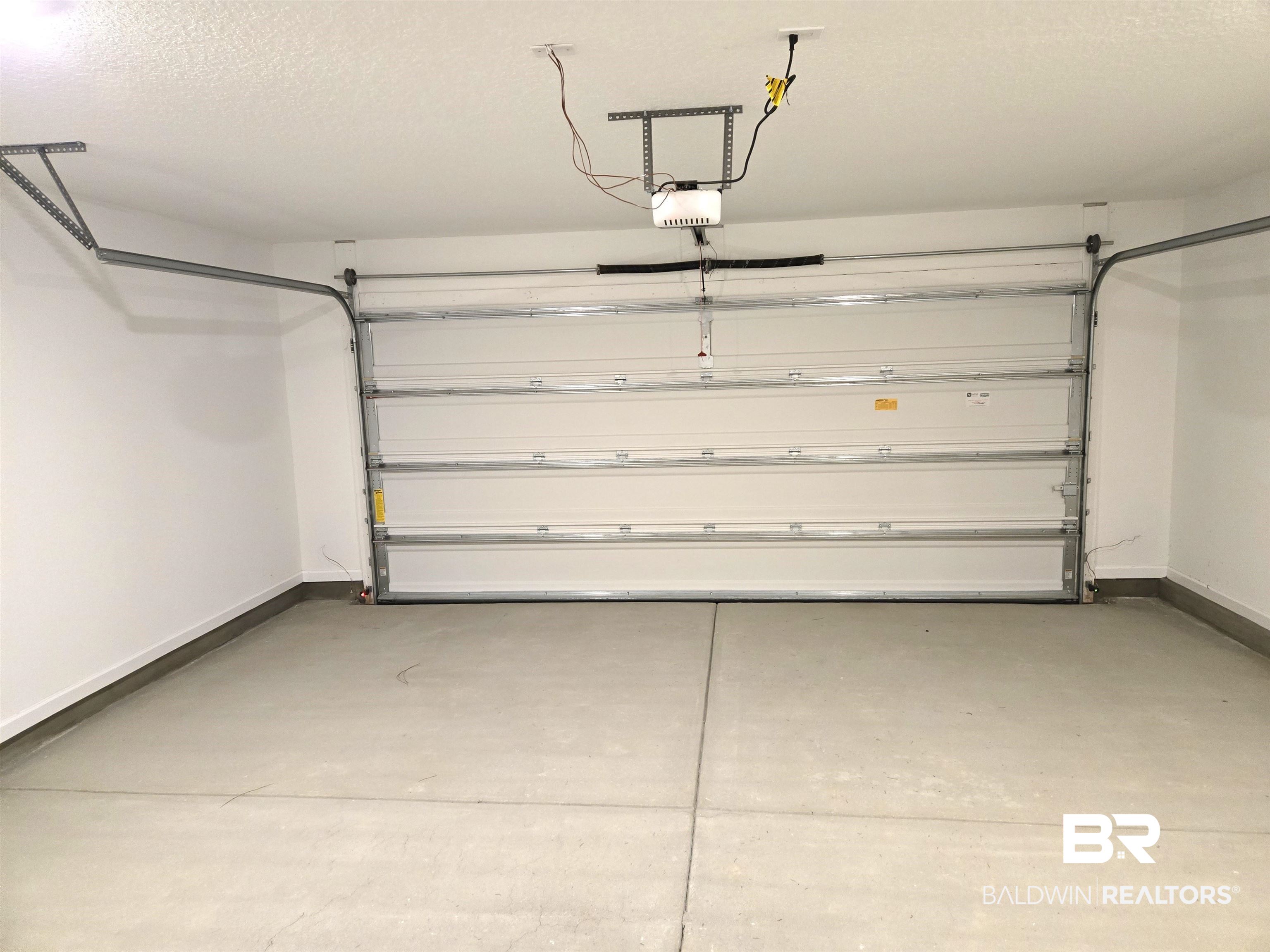 24385 Ringneck Loop Elberta, AL 36530 - Photo 29 of 33 Garage featuring a garage door opener