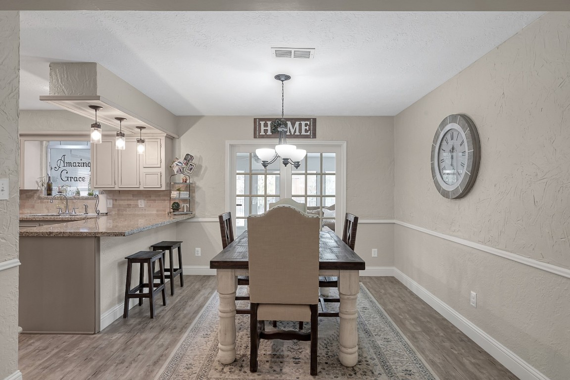 8 Cambridge Road Conroe, TX 77304 - Photo 10 of 44 a view of a dining room with furniture window and wooden floor