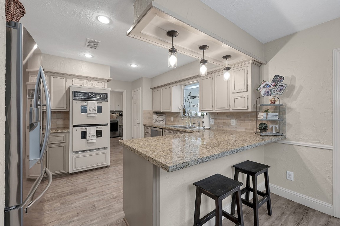 8 Cambridge Road Conroe, TX 77304 - Photo 13 of 44 a kitchen with white cabinets and counter space