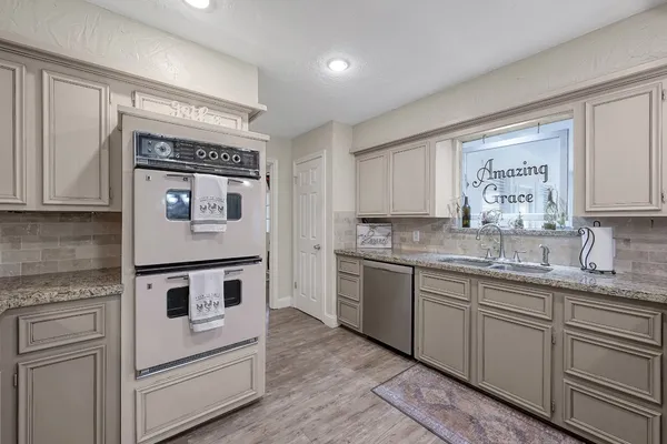 a kitchen with white cabinets and counter space