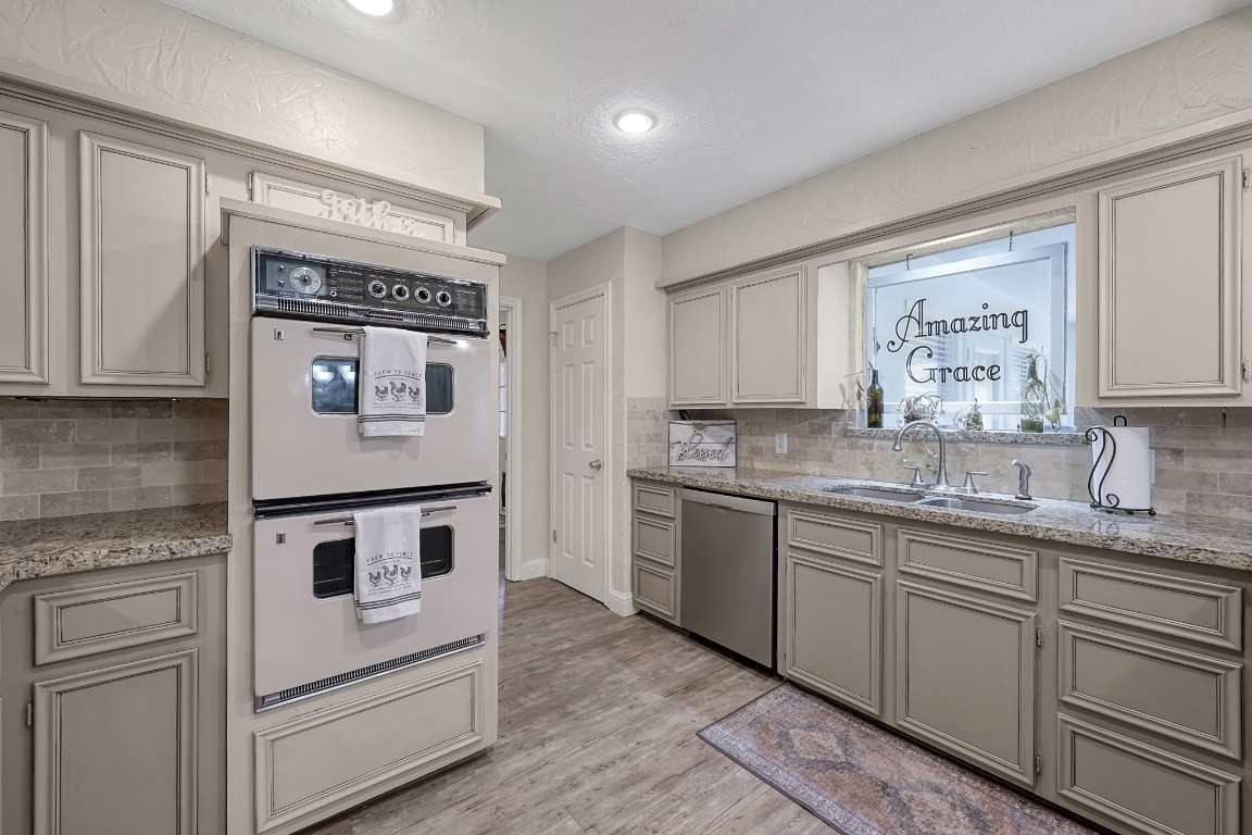8 Cambridge Road Conroe, TX 77304 - Photo 14 of 44 a kitchen with granite countertop cabinets stainless steel appliances and a sink