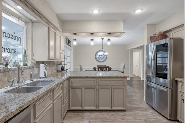 a kitchen with a sink cabinets and window