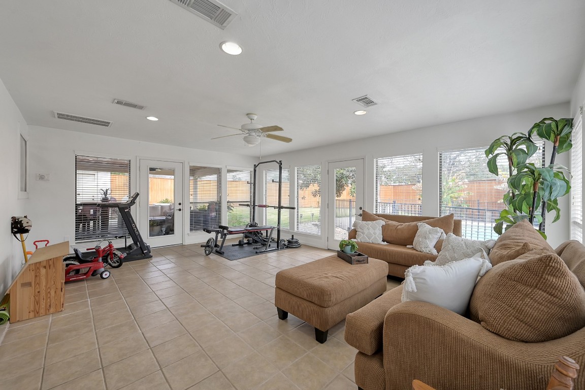 8 Cambridge Road Conroe, TX 77304 - Photo 19 of 44 a living room with furniture and floor to ceiling windows