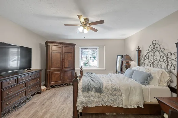 a bedroom with a bed couch and a window