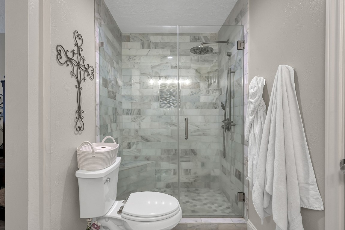 8 Cambridge Road Conroe, TX 77304 - Photo 26 of 44 a bathroom with a shower a toilet and a sink