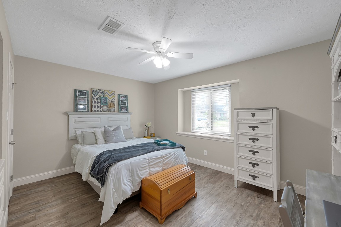 8 Cambridge Road Conroe, TX 77304 - Photo 27 of 44 a bedroom with a bed and a window