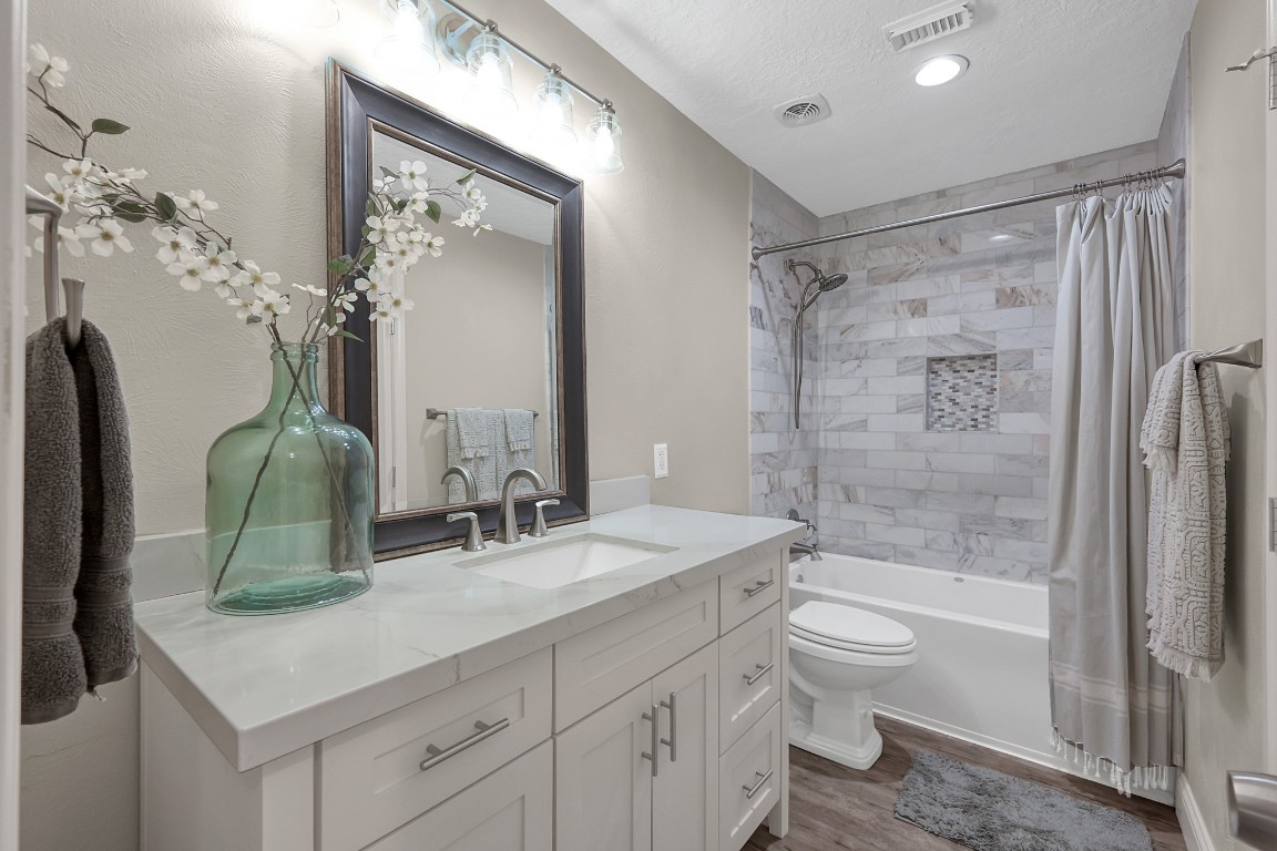 8 Cambridge Road Conroe, TX 77304 - Photo 29 of 44 a bathroom with a double vanity sink toilet mirror and bathtub
