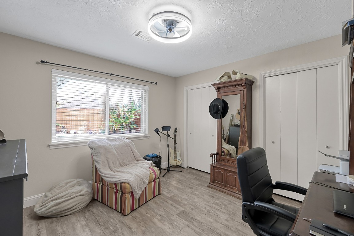8 Cambridge Road Conroe, TX 77304 - Photo 30 of 44 a bedroom with furniture and a window