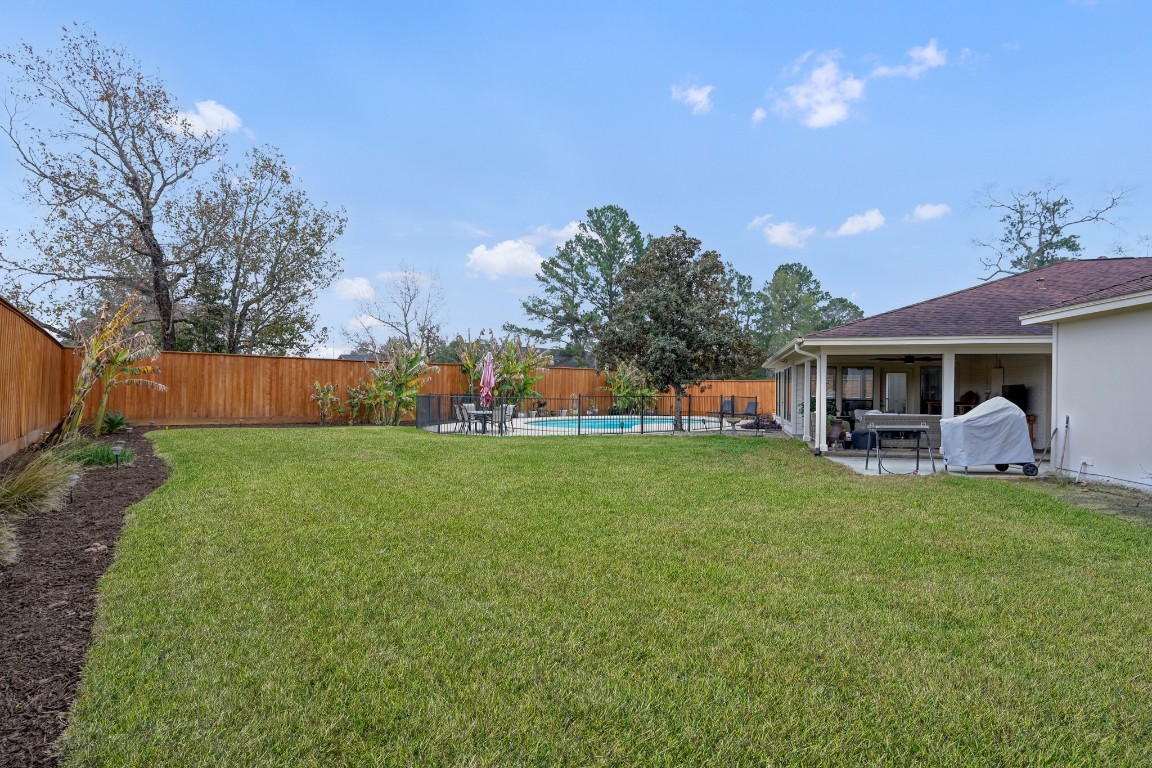 8 Cambridge Road Conroe, TX 77304 - Photo 37 of 44 a front view of a house with a garden and plants