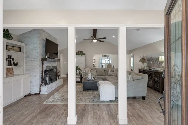 a view of living room kitchen with furniture and wooden floor