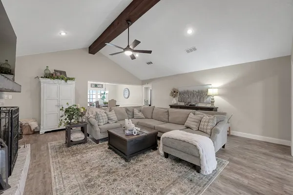 a living room with furniture and a chandelier