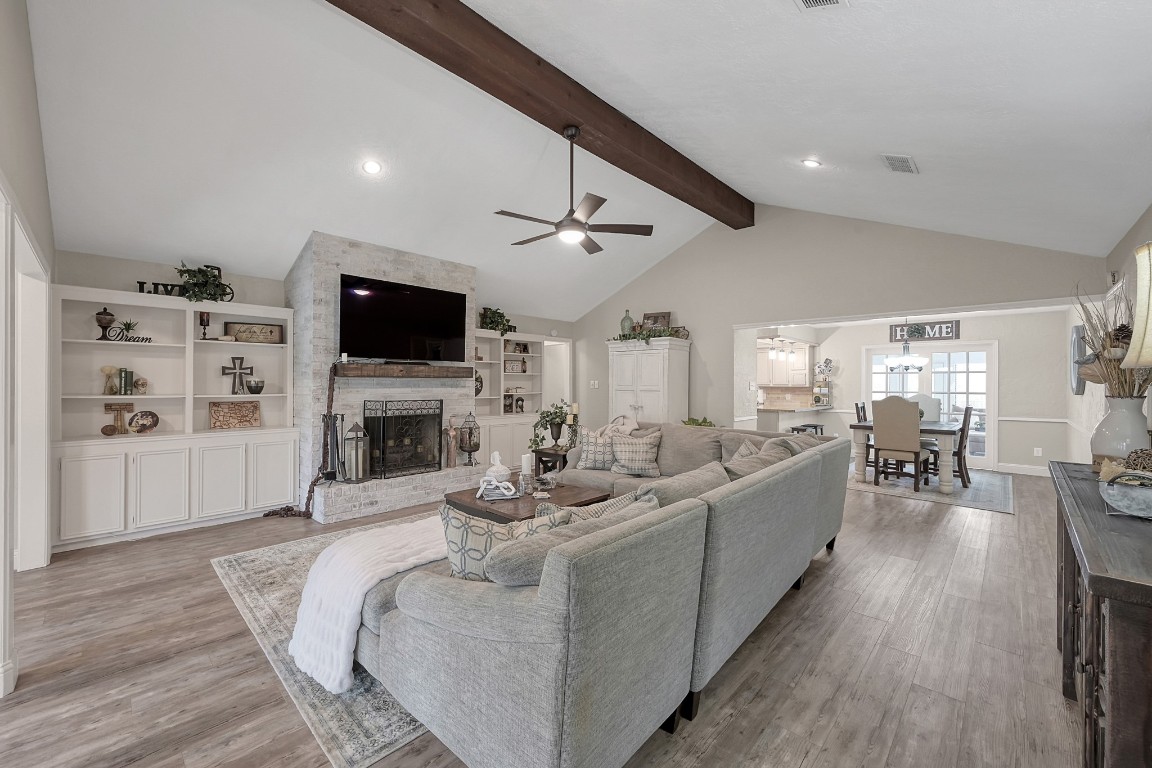 8 Cambridge Road Conroe, TX 77304 - Photo 7 of 44 a living room with furniture a fireplace and a flat screen tv