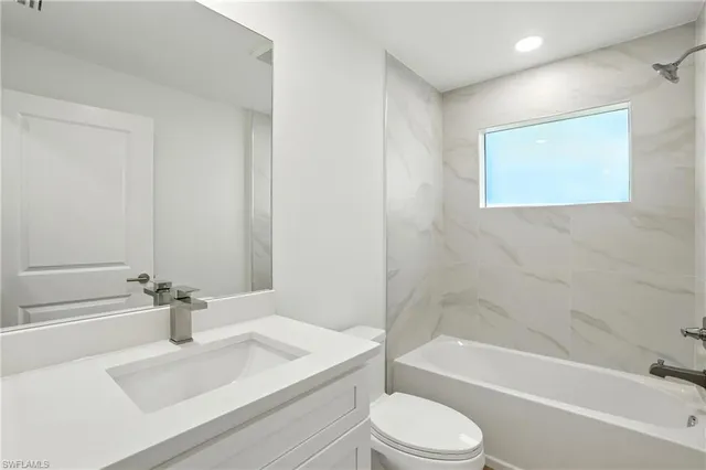 a bathroom with a sink a toilet and bathtub