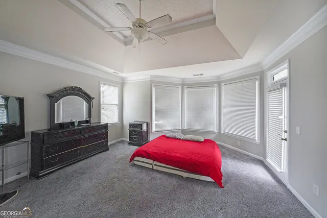 a bedroom with bed and a chandelier