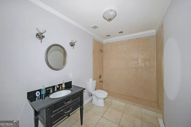 a bathroom with a toilet a sink and a mirror