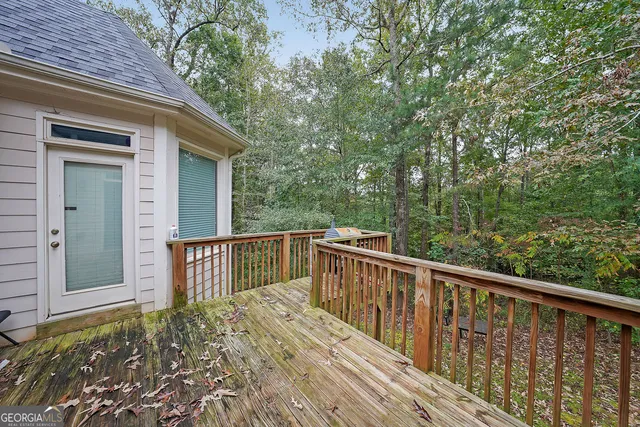 a balcony with wooden floor and fence