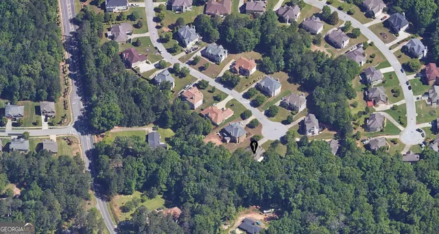 an aerial view of a house with a yard and garden