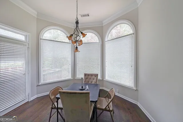 a view of a dining room with furniture window and wooden floor