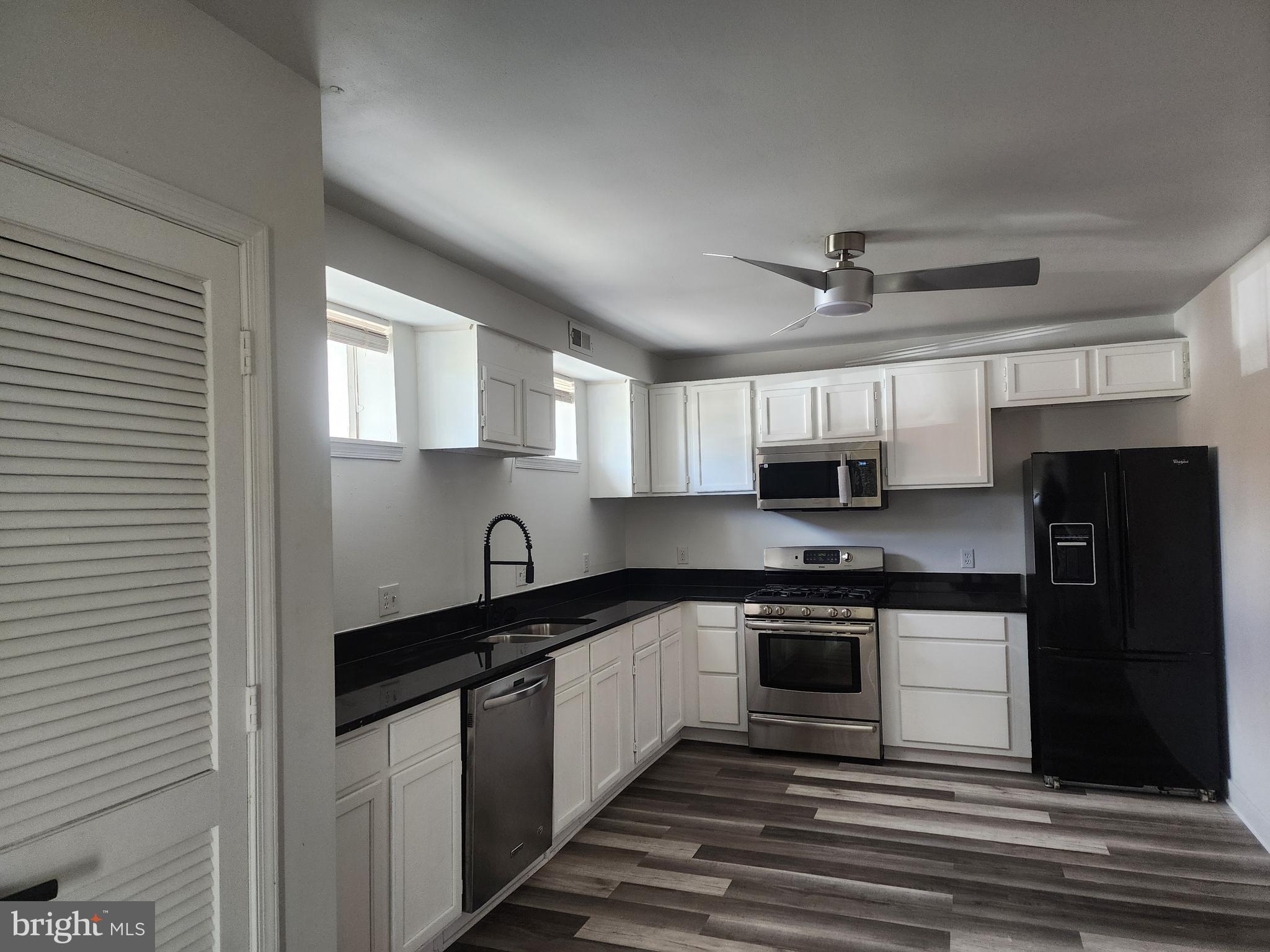 606 Stuart Street, Unit 1 Fredericksburg, VA 22401 - Photo 1 of 13 a kitchen with stainless steel appliances granite countertop a sink stove and refrigerator