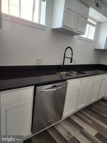 a close view of sink and cabinets