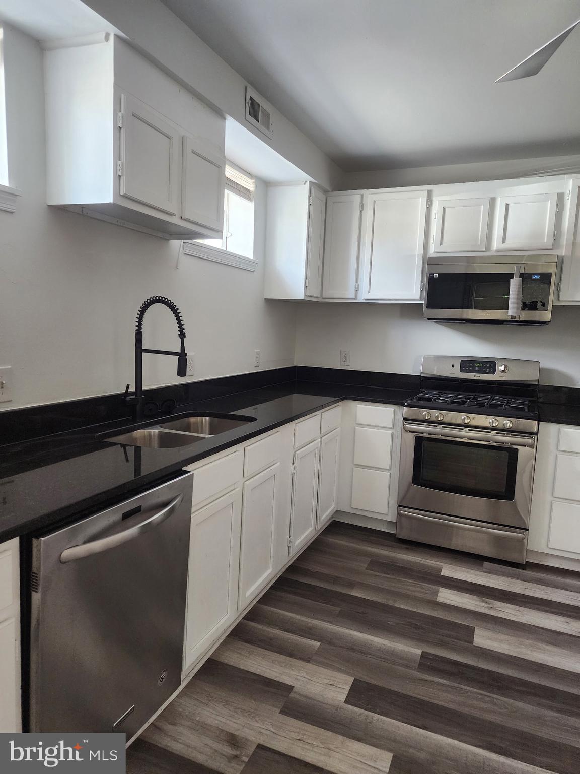 606 Stuart Street, Unit 1 Fredericksburg, VA 22401 - Photo 13 of 13 a kitchen with granite countertop a stove and a sink