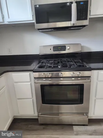 a stove top oven sitting inside of a kitchen