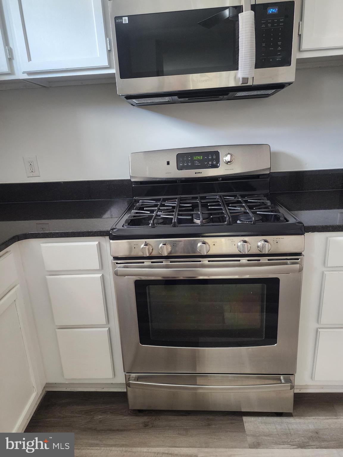 606 Stuart Street, Unit 1 Fredericksburg, VA 22401 - Photo 2 of 13 a stove top oven sitting inside of a kitchen