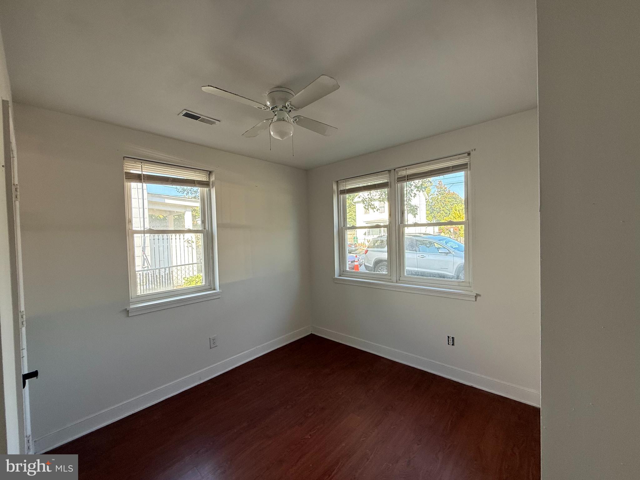 606 Stuart Street, Unit 1 Fredericksburg, VA 22401 - Photo 8 of 13 a view of an empty room with a window and wooden floor