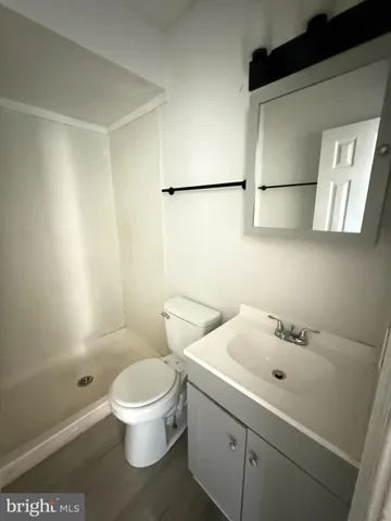 a white toilet sitting next to a bathroom sink