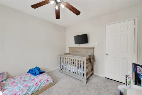 a bedroom with a bed and flat screen tv