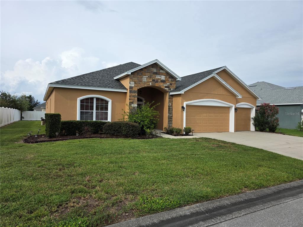 a front view of a house with a yard and garage