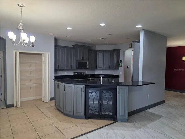 a kitchen with stainless steel appliances granite countertop a refrigerator and a stove top oven