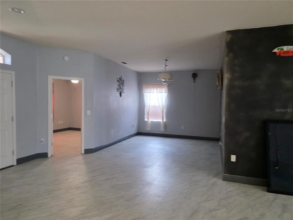 2850 Sheldon Street Lakeland, FL 33813 - Photo 12 of 23 an empty room with wooden floor and windows