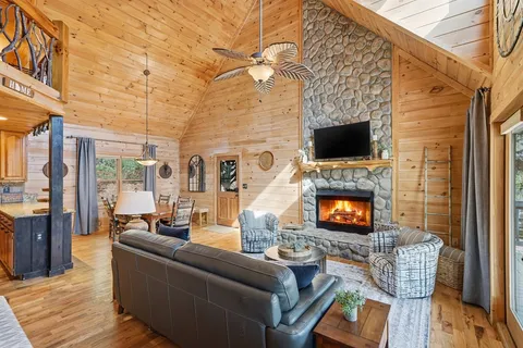 a living room with furniture a flat screen tv and a fireplace
