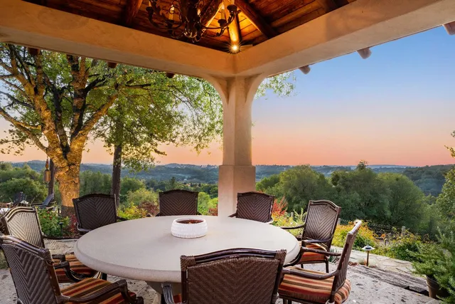 a view of a dining room with furniture wooden floor and chandelier