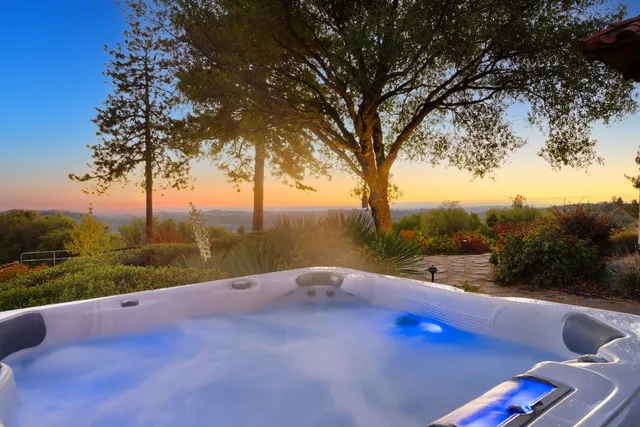 a dining room with furniture a chandelier and wooden floor
