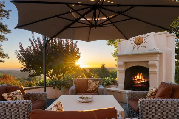 a kitchen with stainless steel appliances granite countertop a sink a stove a refrigerator and island with wooden floor