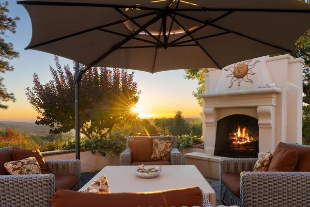 a kitchen with stainless steel appliances granite countertop a sink a stove a refrigerator and island with wooden floor