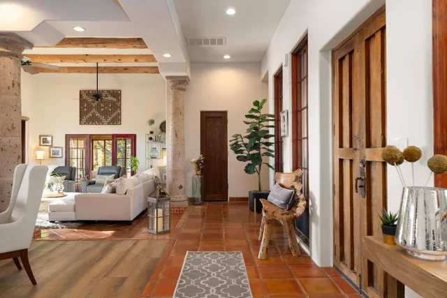a living room with furniture and a floor to ceiling window