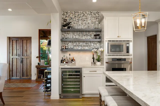 a bathroom with a granite countertop sink a mirror and shower