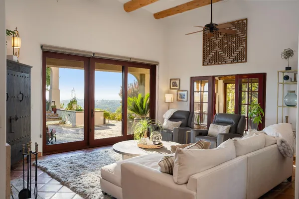 a view of a yard with plants and wooden fence