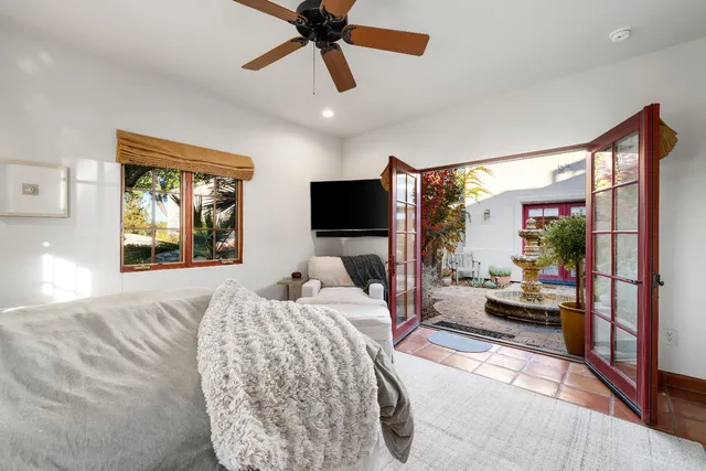 a view of a house with a yard and large tree
