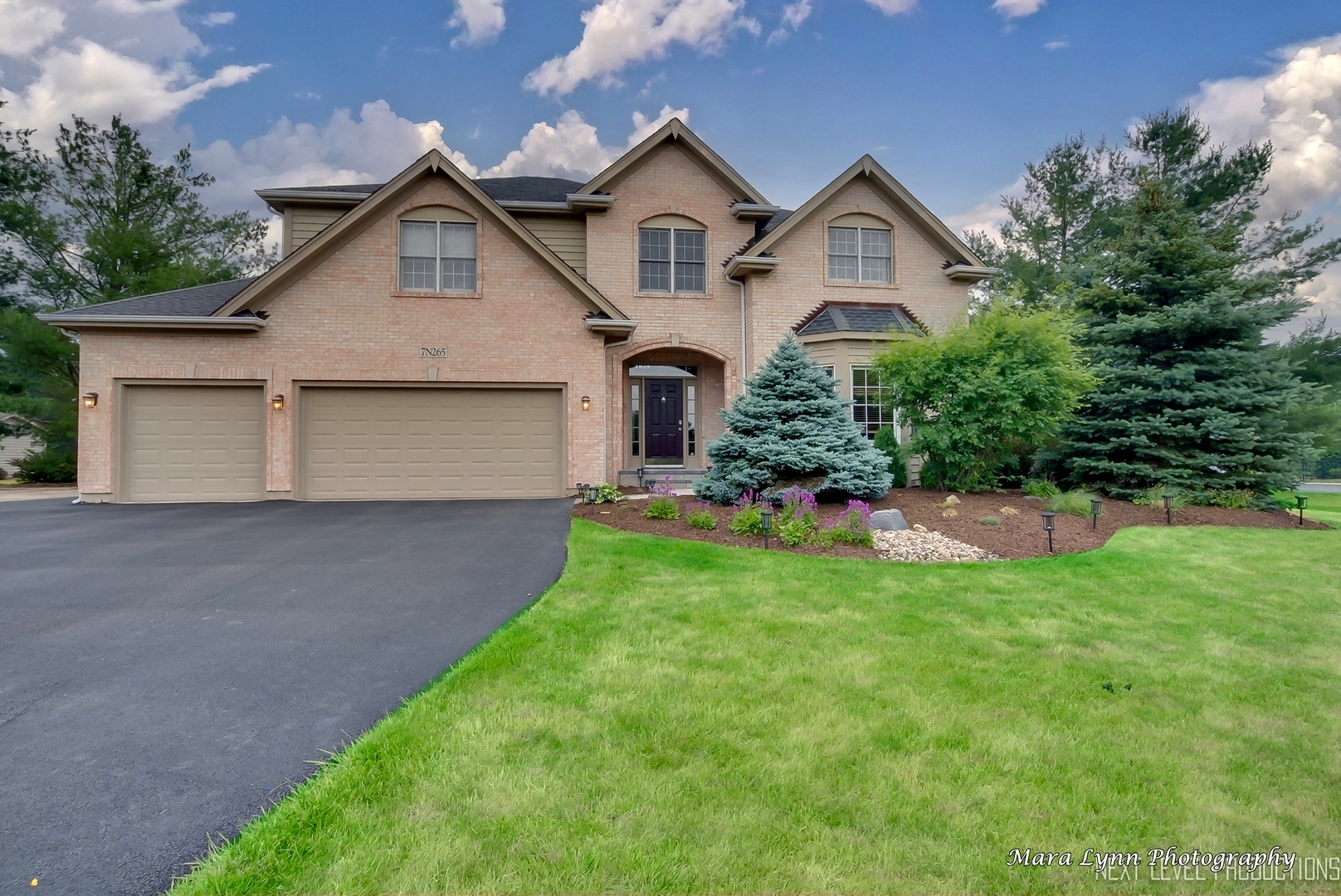 a front view of a house with a yard and garage