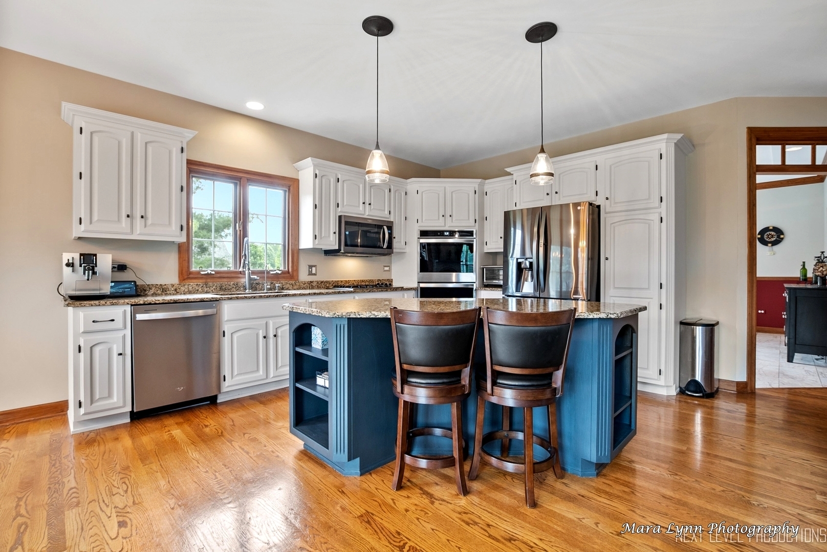 7N265 Ridge Line Road St. Charles, IL 60175 - Photo 8 of 46 a kitchen with kitchen island granite countertop wooden floors appliances and white cabinets