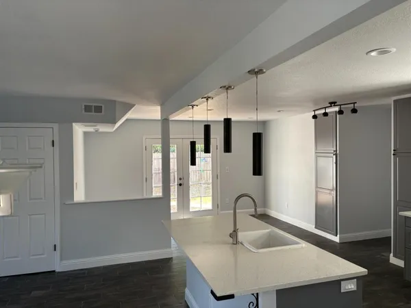 a kitchen with a sink a stove and cabinets