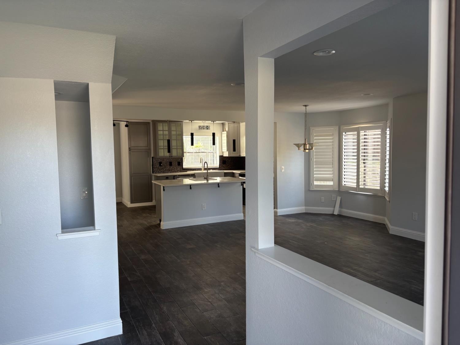8111 Aztec Way Antelope, CA 95843 - Photo 9 of 17 an empty room with wooden floor kitchen view and a living room