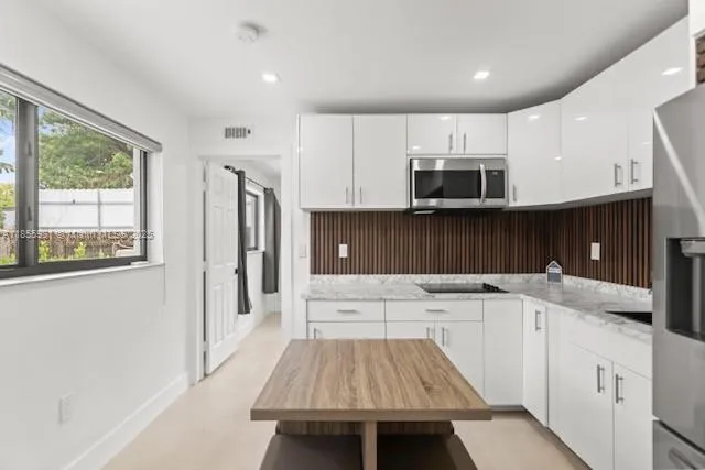 a kitchen with a sink a stove and a refrigerator
